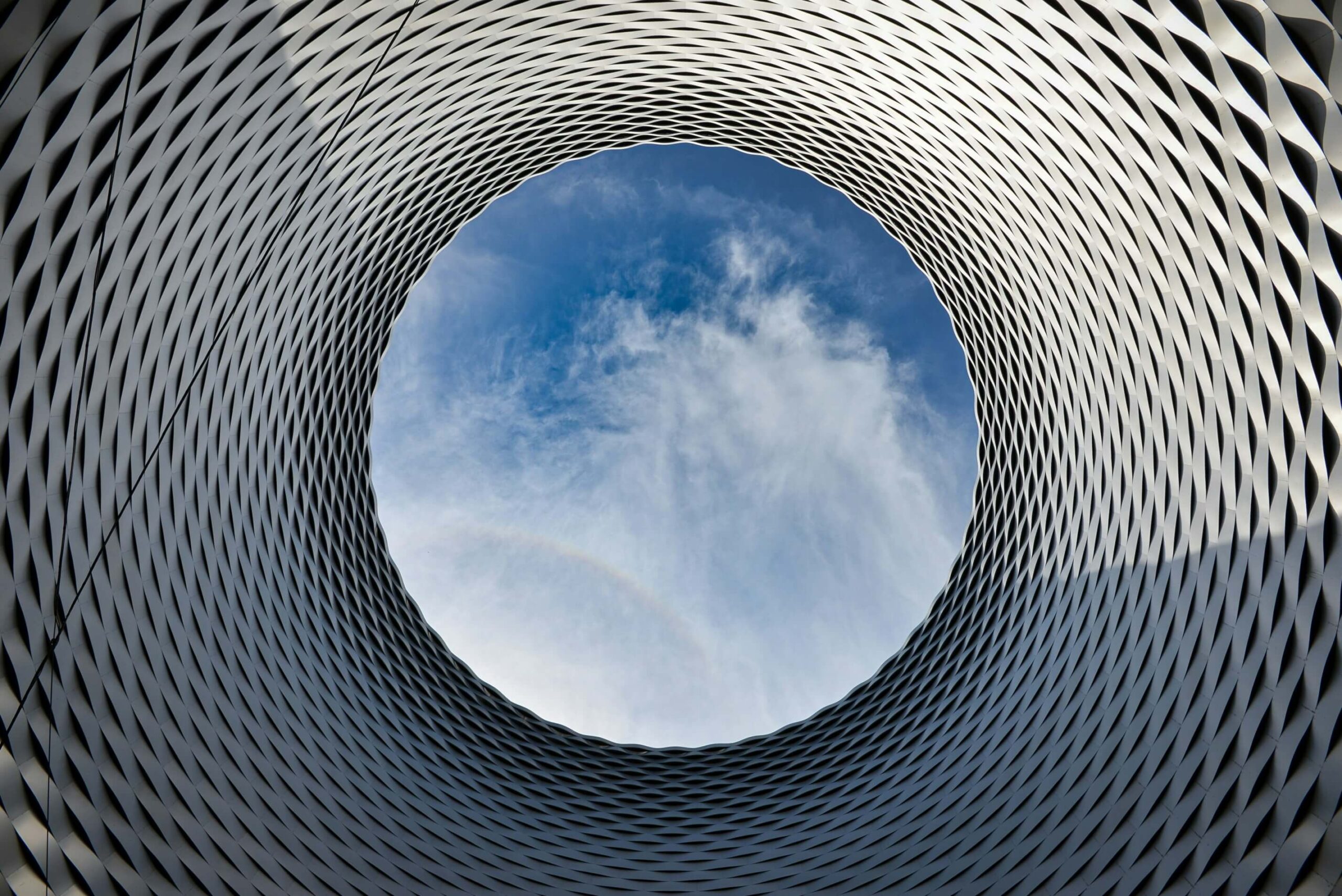 View through a metal cylinder into the sky